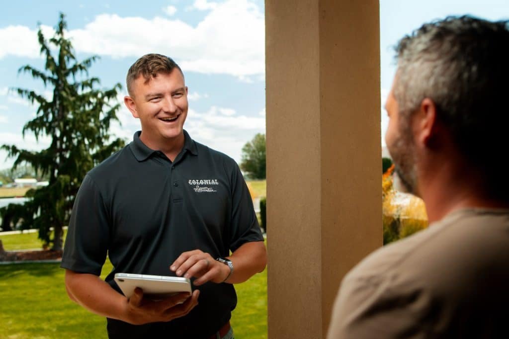 Colonial Lawn & Garden lawn care expert talking to client